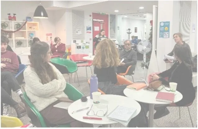 Group meeting in a bright, modern office space.